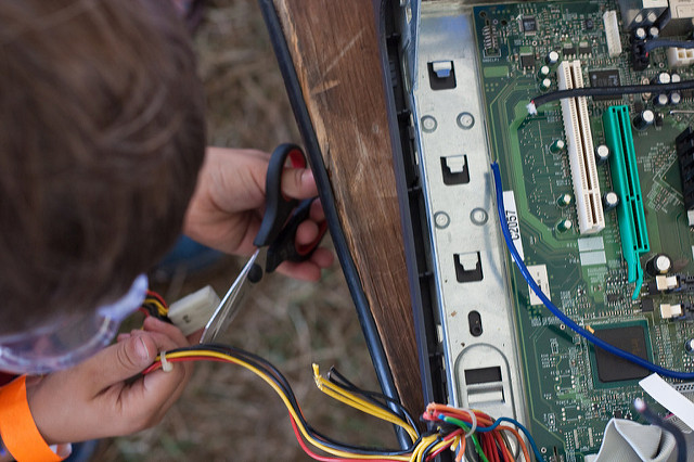 Kid deconstructing an appliance Kid deconstructing an appliance